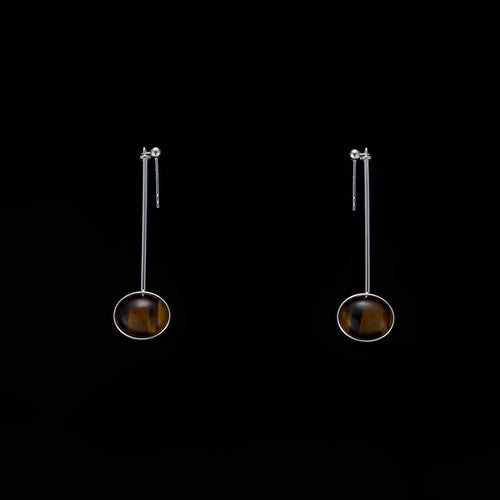 Minimalist vertical drop earrings in 925 sterling silver and natural Tiger Eye. Featuring a unique composite sphere and muted lustre finish. Architectural jewelry by Saël.